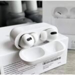img_7281 - The Phonepreneur Global White wireless earbuds in an open charging case resting on a product box.