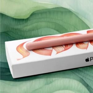 img_7315 - The Phonepreneur Global Pink curved accessory resting on a white packaging box with an orange design, against a green fabric backdrop.