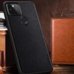 img_8289 - The Phonepreneur Global Black textured phone case with circular fingerprint sensor on the back, leaning against a wooden surface and a brown leather wallet.