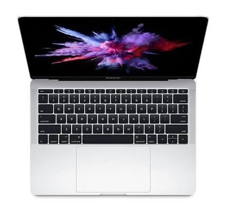 Top-down view of a silver laptop open to reveal a black keyboard and a colorful abstract wallpaper on the screen