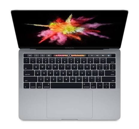 Top-down view of a silver laptop with a colorful splash wallpaper on the screen and a dark keyboard below it.