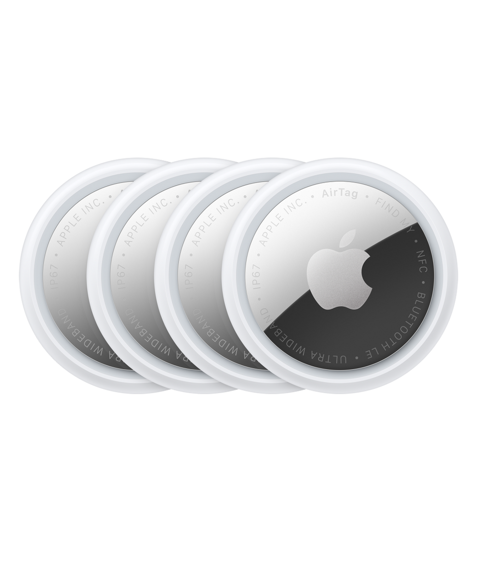 Four overlapping Apple AirTag trackers with silver faces and the Apple logo on a black background.