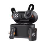 Open charging case with black wireless earbuds featuring orange accents; a USB receiver labeled HOLLYLAND sits beside the case.