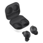White wireless earbuds with charging case, case open and two earbuds placed nearby, showing the inner charging slots.