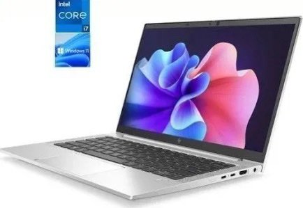 Silver laptop opened at an angle displaying a vibrant wallpaper; floating Intel Core i7 and Windows 11 stickers nearby.