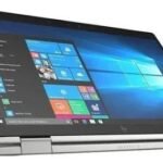img_8626 - The Phonepreneur Global Slim silver 2-in-1 laptop in tent mode with Windows 10 desktop on screen and a stylus docked at the side.