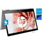 HP convertible laptop in tent/stand mode with touch icon, displaying a floral wallpaper and HP logo on screen; Intel Core i5 and Windows 11 Pro stickers nearby.