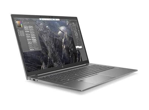 Silver laptop with a cracked screen showing a design/editing workspace on-screen on a white background.